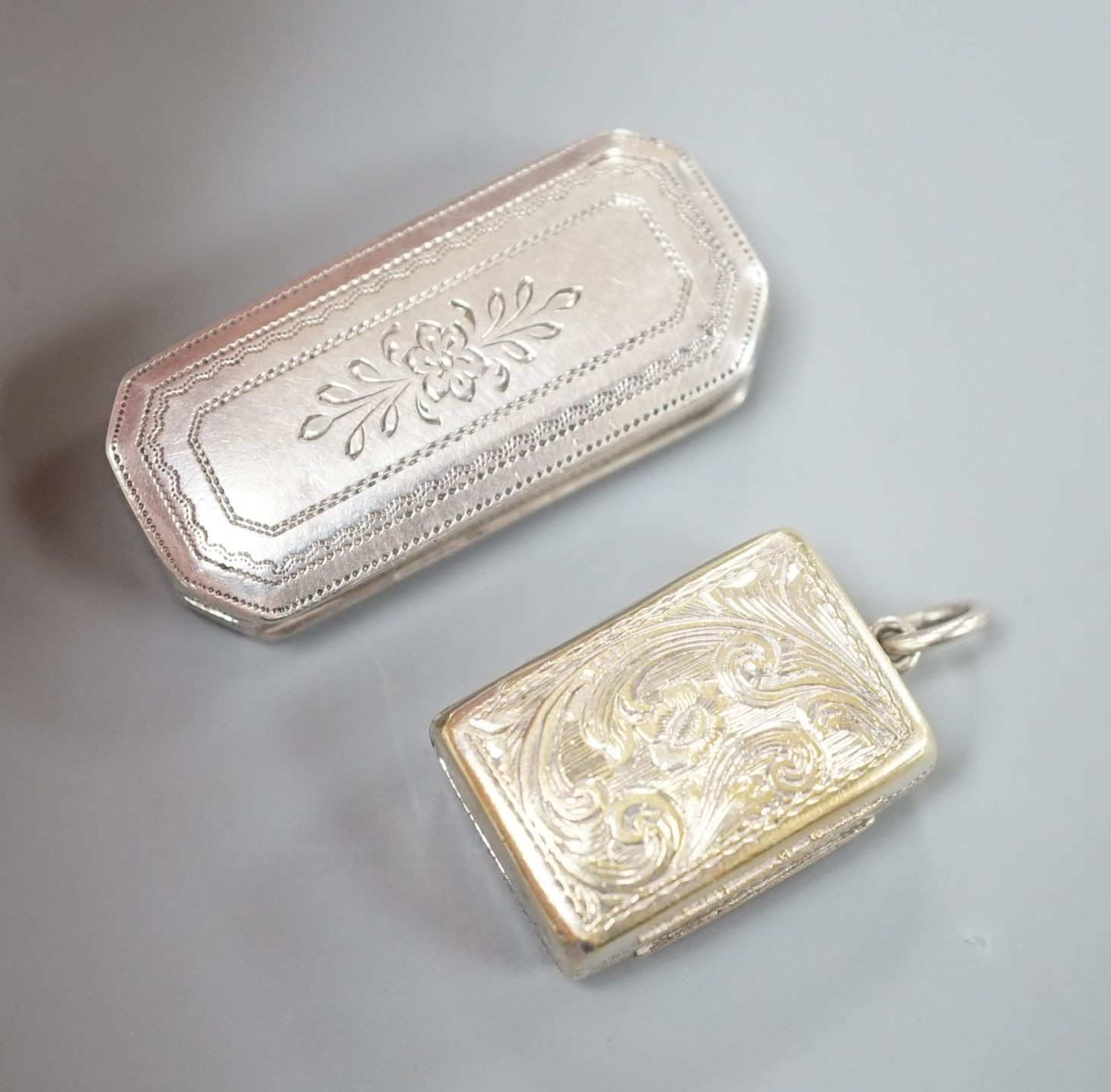 A Victorian silver gilt vinaigrette, by Edward Smith, Birmingham, 1848, 22mm and an earlier octagonal silver vinaigrette by Joseph Wilmore, Birmingham, 1818.